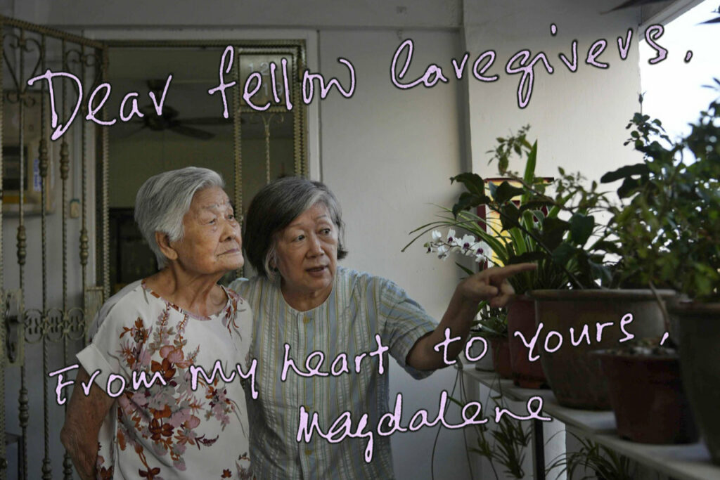 A photo of a postcard with senior collaborator, Magdalene, and her mother looking at potted plants along HDB corridor with text superimposed on the card : Dear fellow Caregivers, From my heart to Yours, Magdalene.