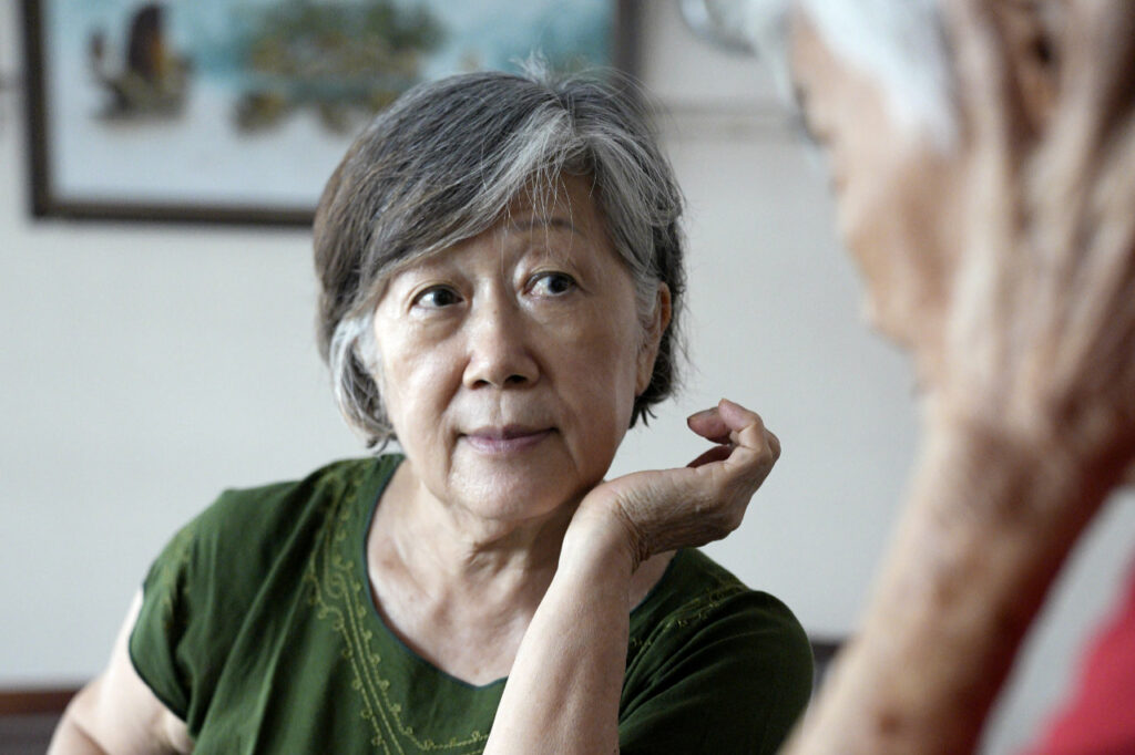 An over the shoulders shot of senior collaborator, Magdalene, having a conversation with her mother.