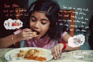 Little girl eating a plate of food with her right hand with a message from her to Devi overlayed on top of image.